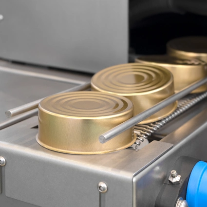 Sistema automático de cerrado de latas metálicas, utilizado en líneas de envasado para conservas, comida preparada o pet food húmedo